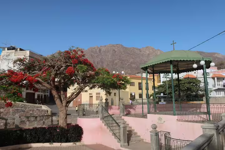 Charming São Nicolau square with vibrant flora, historic architecture, and mountain backdrop on 4x4 island tour.