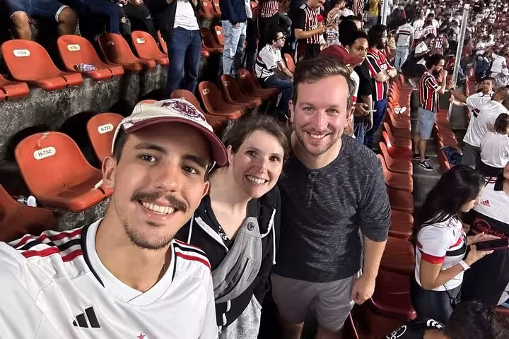 Travelers with a local host at a São Paulo football match, part of the join a soccer game experience