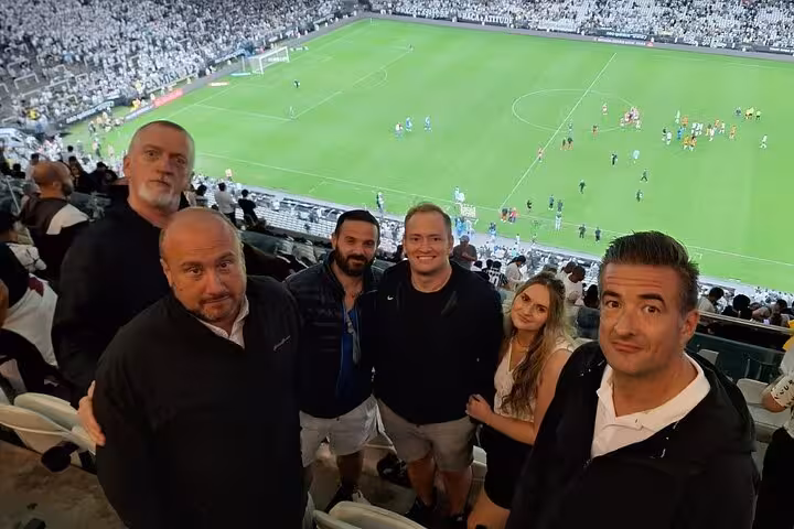 Travelers enjoy a São Paulo soccer match from the stands, part of a local pickup game and fan experience tour