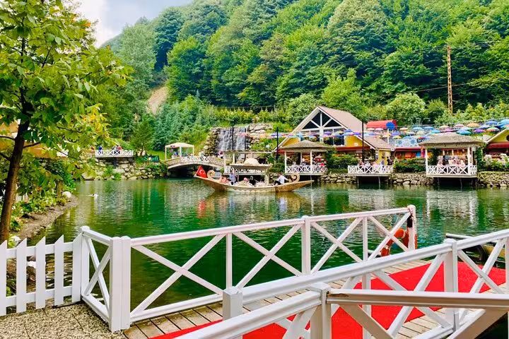 Sapanca Lake waterfront view on Istanbul day trip, Turkish flag boat, cafes and forested hills