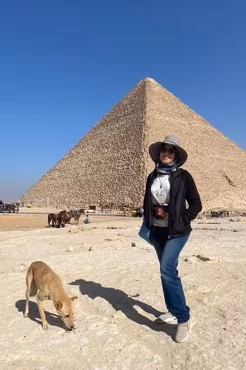 Tour guest by Great Pyramid with stray dog on Saqqara Dahshur Memphis trip, 10% donation to animal rescue