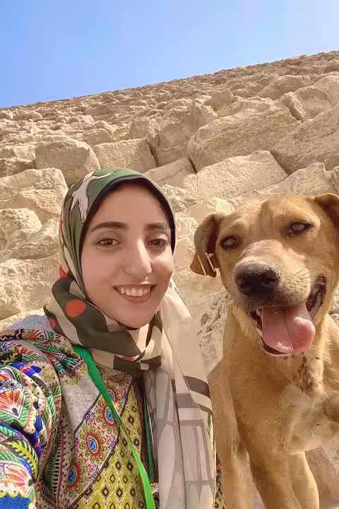 Guide selfie with happy stray dog at Saqqara ruins on Dahshur and Memphis tour, 10% donated to animals