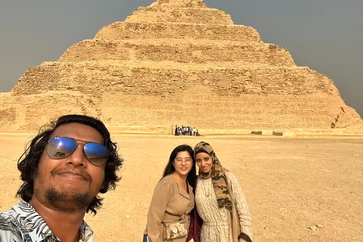 Travelers selfie at Saqqara Step Pyramid on Memphis, Dahshur day tour, supporting stray dogs and cats
