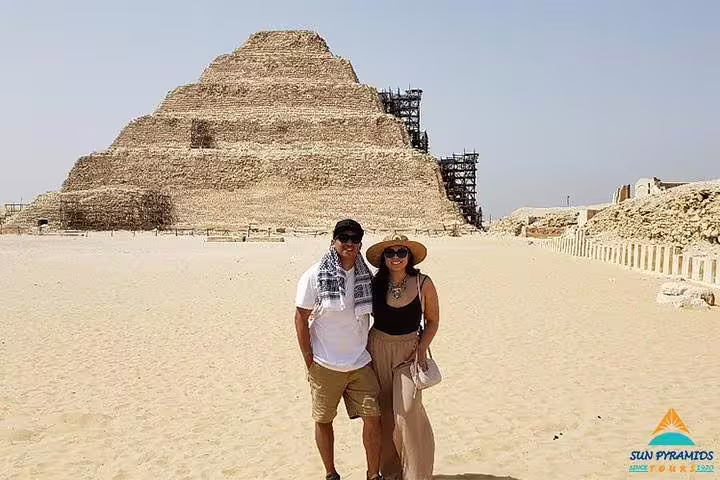 Couple posing at Saqqara Step Pyramid of Djoser, key highlight on Giza Pyramids, Memphis and Dahshur tour