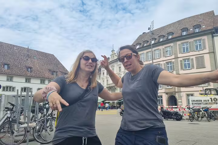 Friends pose in Schaffhausen old town square during a self-guided scavenger hunt walking tour in Switzerland
