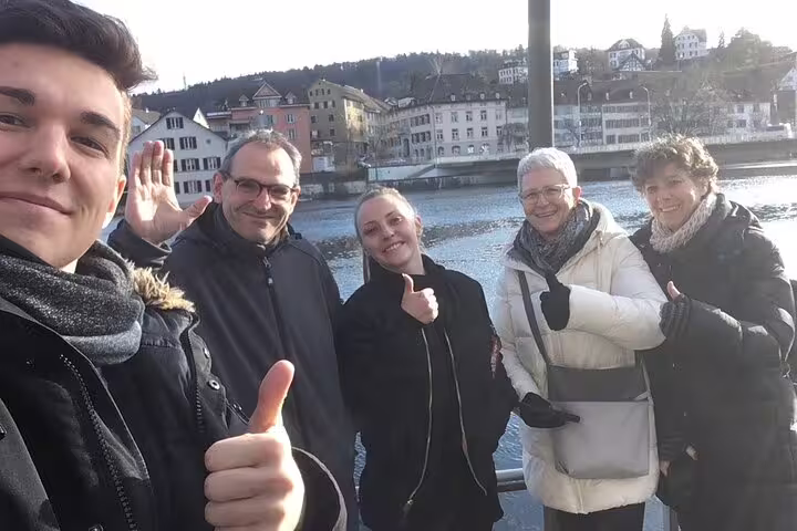 Group selfie by the Rhine River in Schaffhausen on a self-guided scavenger hunt and sights tour, Switzerland