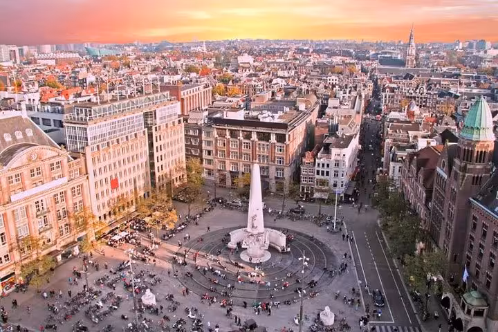 Aerial view of Amsterdam Dam Square at sunset, ideal destination after Schiphol Airport private arrival transfer