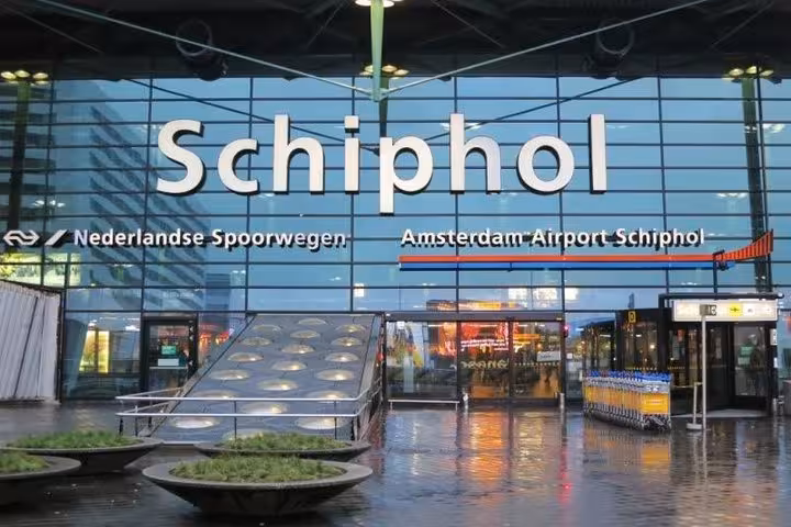 Amsterdam Airport Schiphol entrance sign, meet-and-greet location for private transfer from Schiphol to Rotterdam