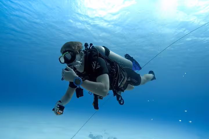 Scuba diver gliding over sandy seabed in Sharks Bay, Sharm El Sheikh, Red Sea diving trip adventure