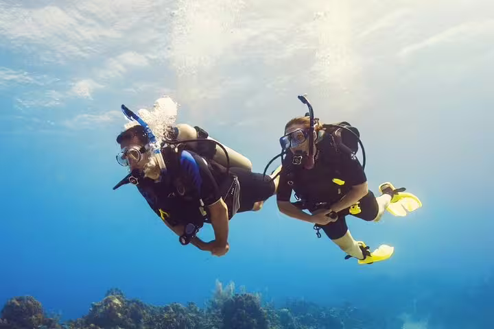 Two scuba divers underwater in Ras Mohamed, Red Sea, on VIP boat diving and snorkeling tour from Sharm