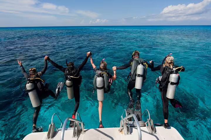 Scuba divers jumping from boat into Red Sea on White Island and Ras Mohammed trip from Sharm El Sheikh