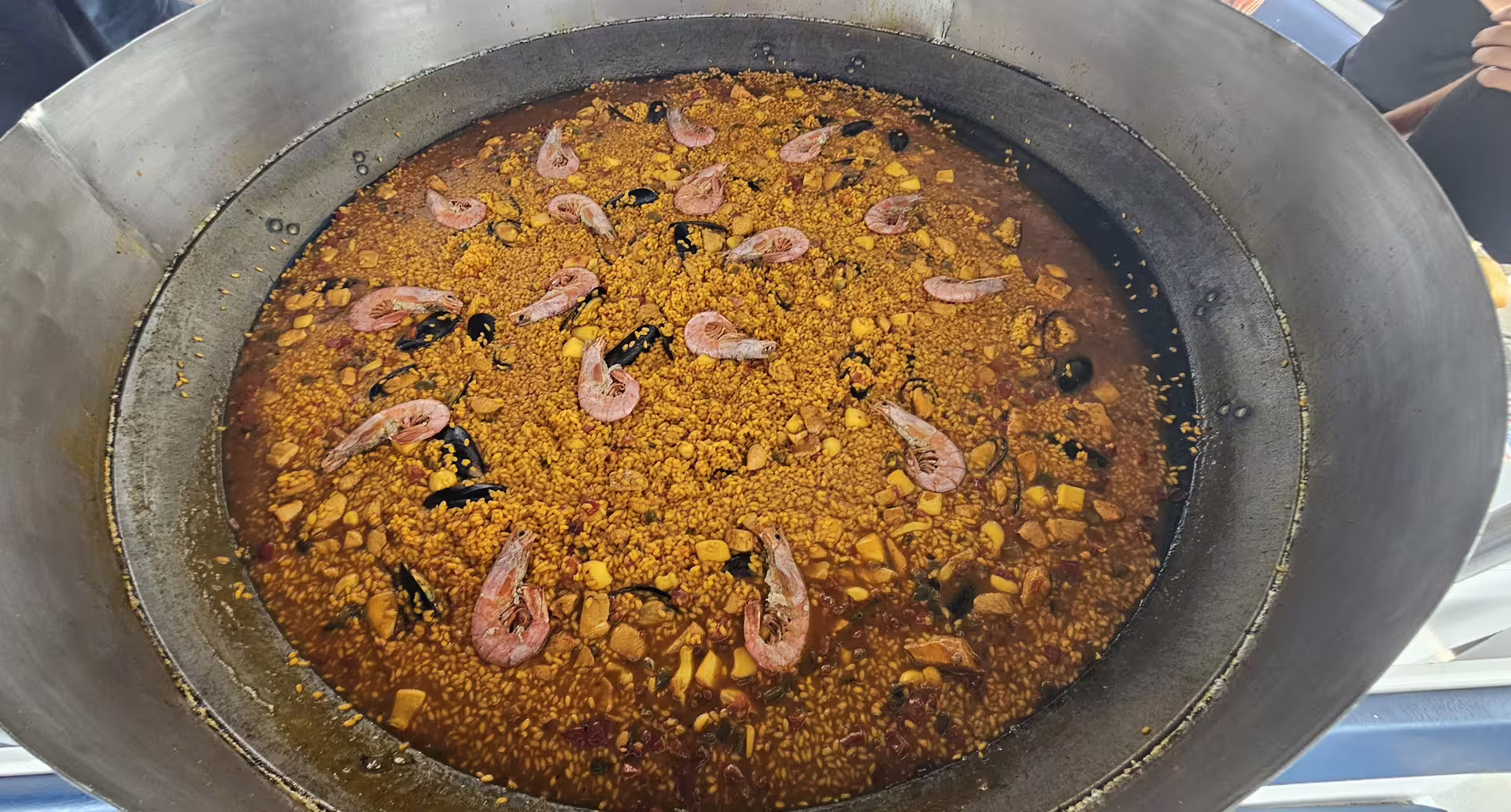Close-up of seafood paella simmering on boat, Ibiza to Illetas Beach Formentera excursion with drinks