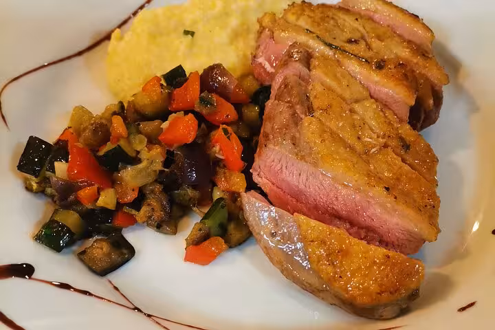 Seared duck breast with Provençal ratatouille and polenta, signature dish from Avignon chef cooking class