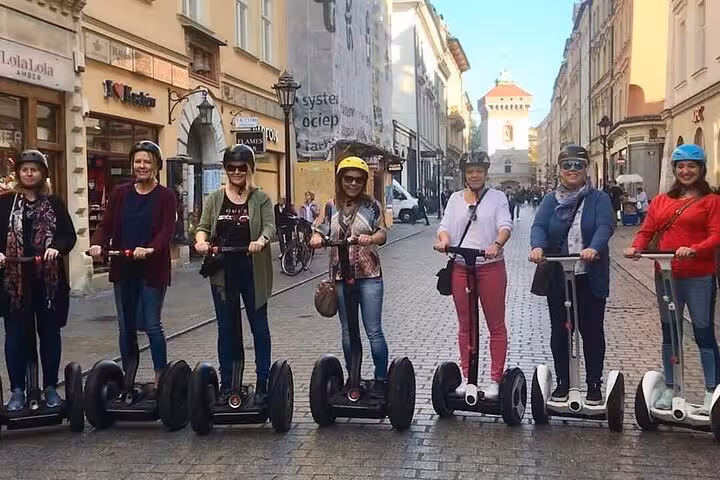 Group enjoying a Segway tour in Krakow's Jewish Quarter, exploring historic streets with vibrant atmosphere.