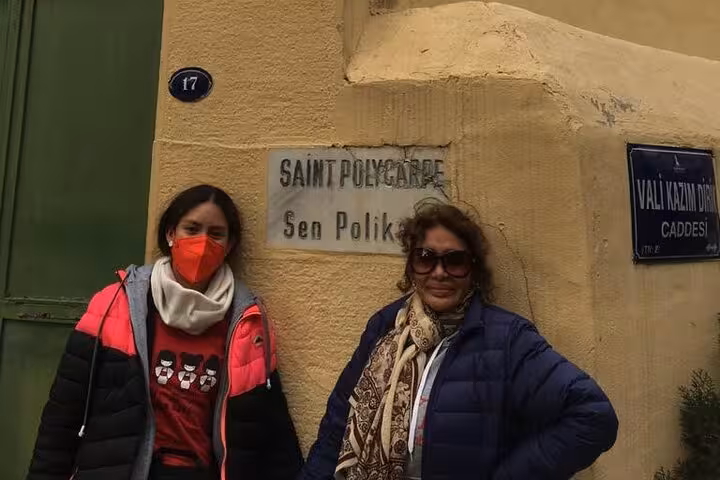 Guests by Saint Polycarp sign in Izmir, private Seven Churches of Revelation tour including Smyrna stop