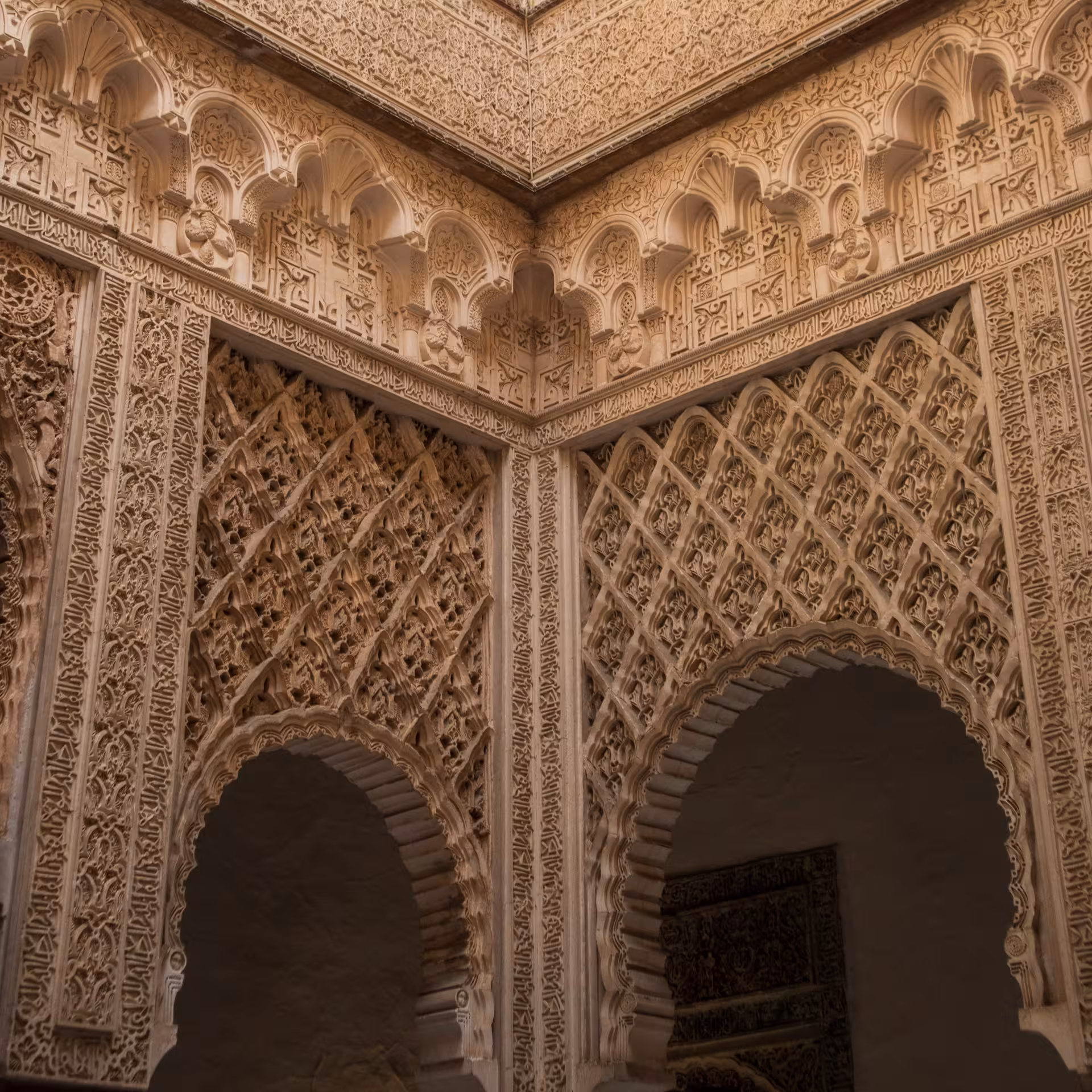 Intricate Moorish architecture in the Real Alcázar of Seville, showcasing stunning geometric patterns and arches.
