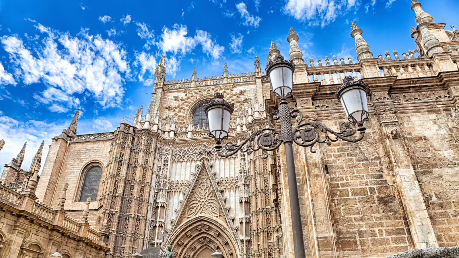Seville Cathedral Gothic facade and street lamps, a highlight stop on a Granada and Alhambra private day trip