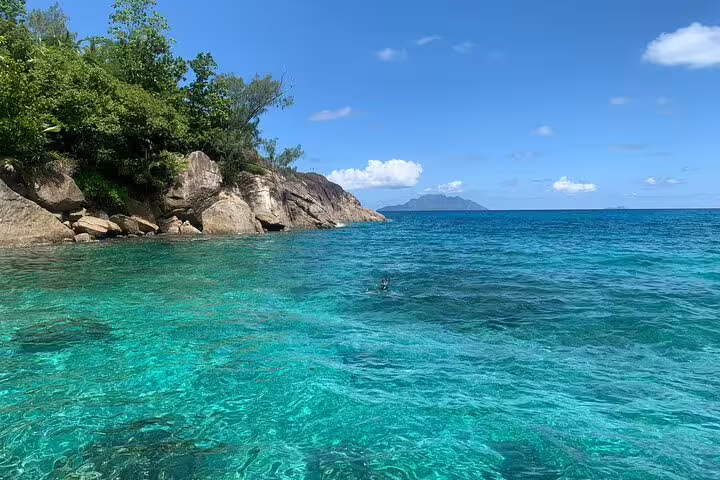 Crystal-clear waters and rocky coastline at Anse Major, ideal for snorkeling adventures in Seychelles.
