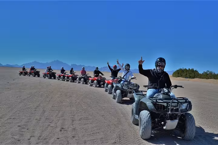 Group ATV quad bikes lined up in Sharm El-Sheikh desert safari, adventure tour with BBQ dinner and show