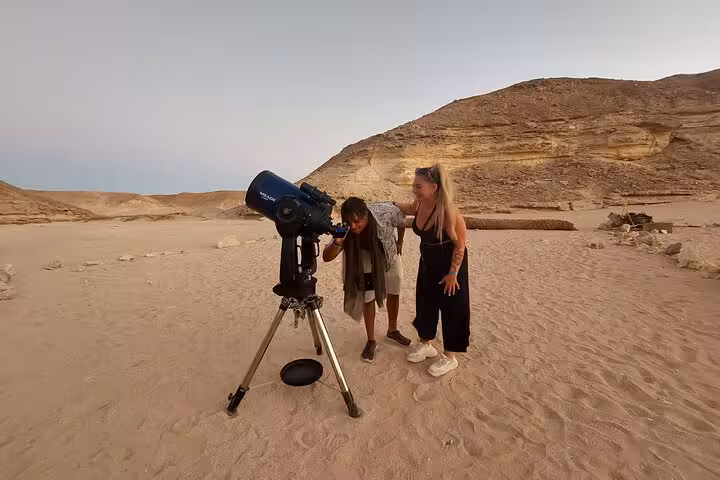 Guests stargaze with a telescope in Sharm El-Sheikh desert on ATV quad safari with BBQ dinner experience