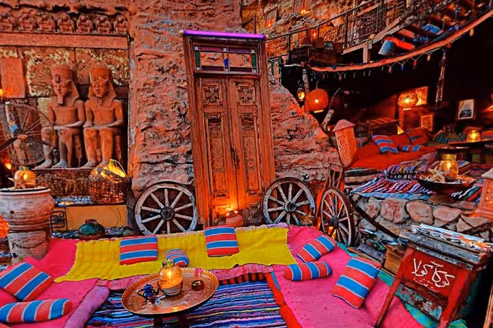 Colorful Bedouin-style lounge in Sharm El-Sheikh restaurant with cushions, lanterns, and included shisha