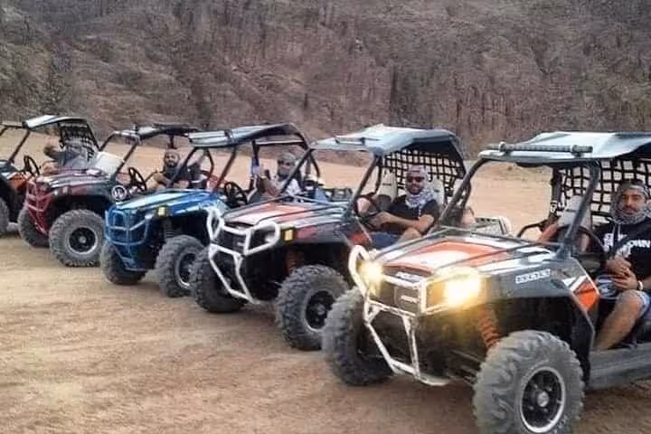 Off-road buggies lined up in Sinai desert for Sharm El Sheikh Bike Camel Canyon Tour adventure