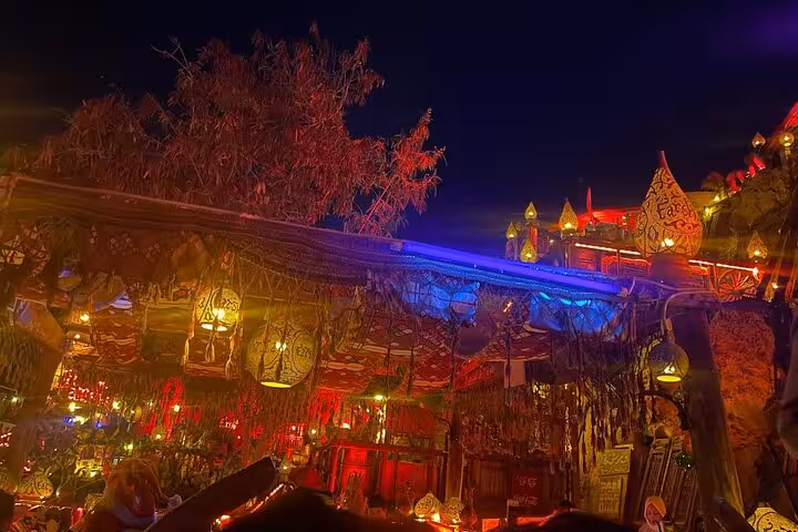 Nighttime Sharm El-Sheikh cafe with glowing lanterns and cozy seating, ideal for shisha and drink tour