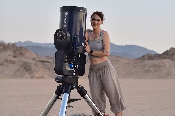 Stargazing stop on Sharm El-Sheikh desert safari, traveler posing by telescope after ATV and BBQ show