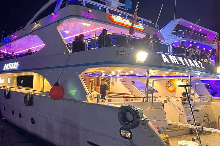 Modern Sharm El Sheikh dinner cruise yacht at night with neon lights, oriental buffet and belly dance show