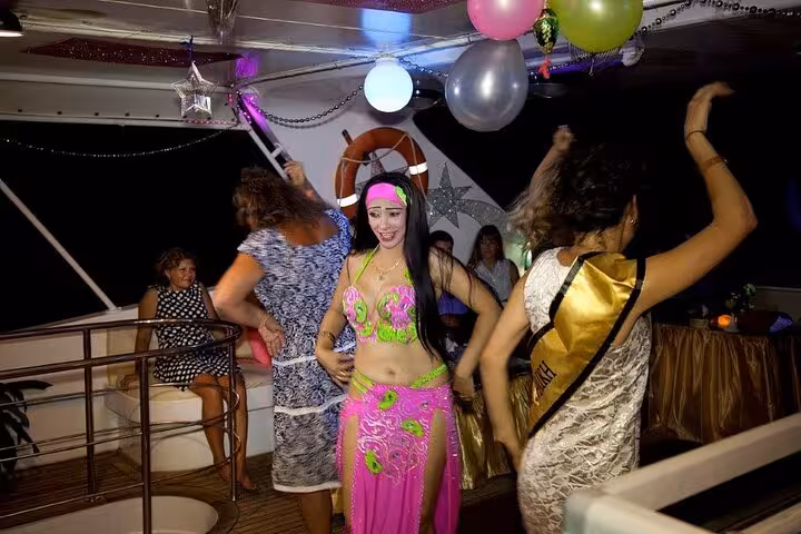 Belly dancer entertaining guests on Sharm El Sheikh evening oriental dinner cruise with live music onboard