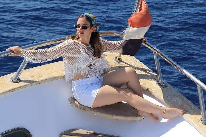 Traveler relaxing on boat deck during Sharm El-Sheikh Ras Mohamed & White Island snorkeling cruise on the Red Sea