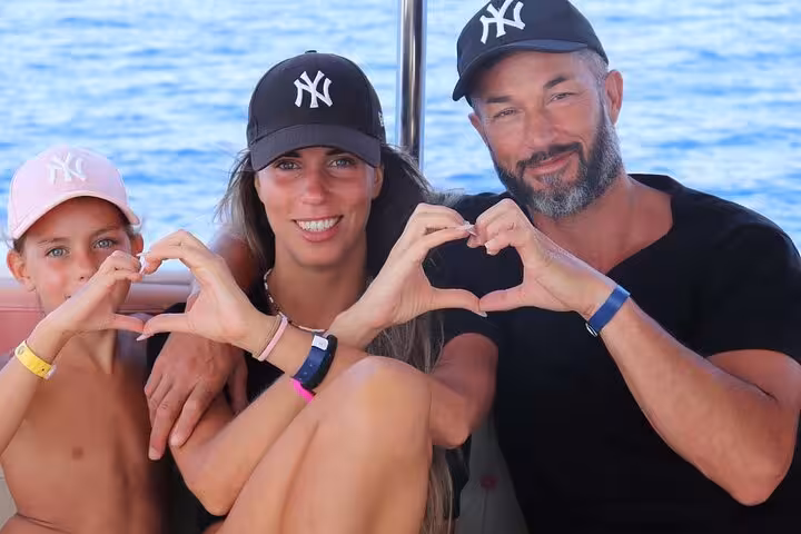 Family posing on a boat in Sharm El-Sheikh, relaxing on Ras Mohamed and White Island snorkeling cruise