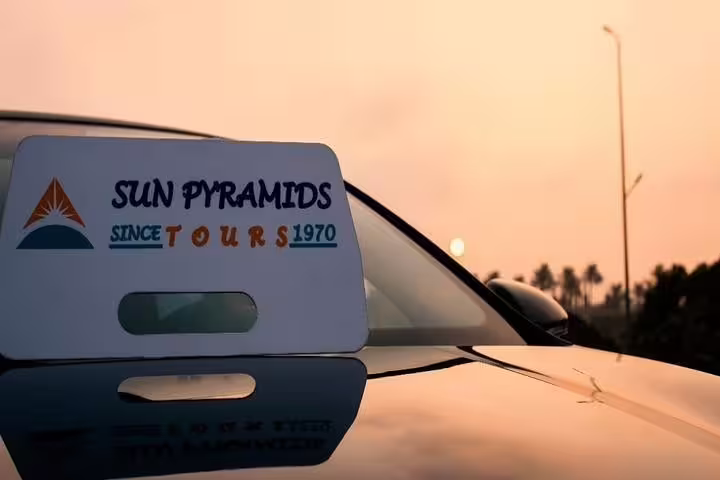 Sun Pyramids Tours sign on private car at sunset for Sharm El Sheikh to Taba transfer in Egypt