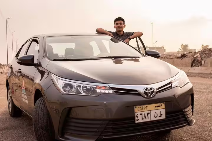 Professional driver with Toyota sedan for Sharm El Sheikh to Taba private transfer on Egypt desert road