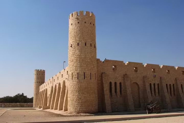 Discover historic architecture at Sheikh Faisal Museum, featuring traditional Qatari fort design under clear skies.
