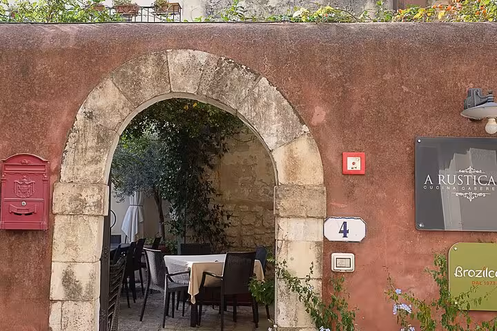 Charming Sicilian courtyard with rustic decor, capturing the essence of Il Commissario Montalbano's filming locations.