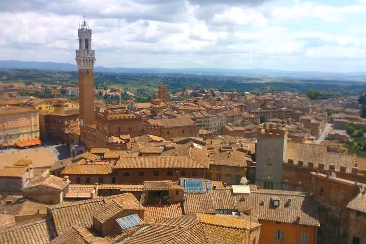 Aerial view of Siena's medieval rooftops and Torre del Mangia, Tuscany, perfect for small group wine tasting tours.