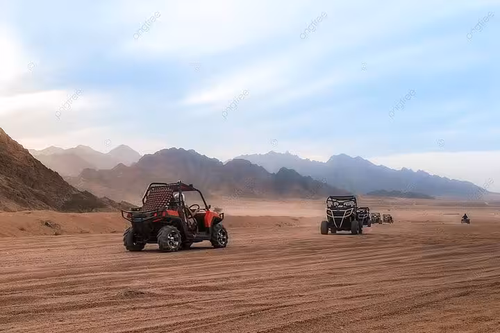 Convoy of buggies racing across Sinai Desert plains from Sharm El Sheikh, private off-road safari with mountains