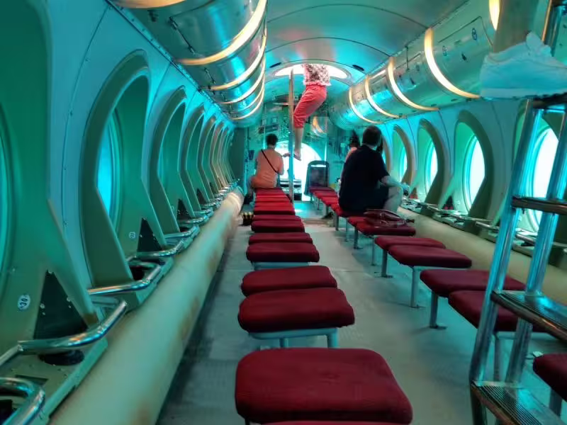 Inside Sindbad Submarine cabin with panoramic windows and red seats for a Red Sea underwater tour in Hurghada