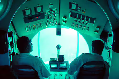 Inside Sindbad Submarine cockpit with pilots, heading to Red Sea coral reef viewing on Hurghada tour