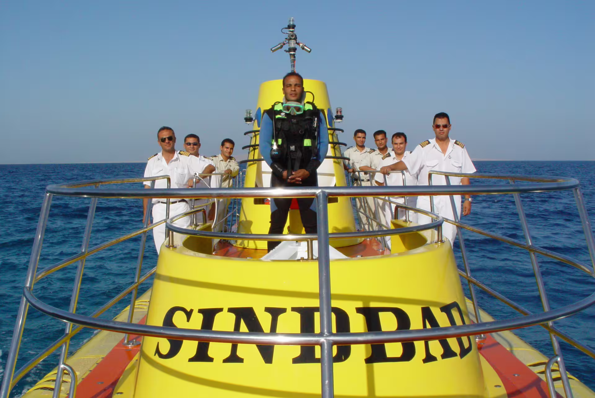 Sindbad Submarine crew on yellow deck in Hurghada Red Sea, ready for underwater coral reef excursion