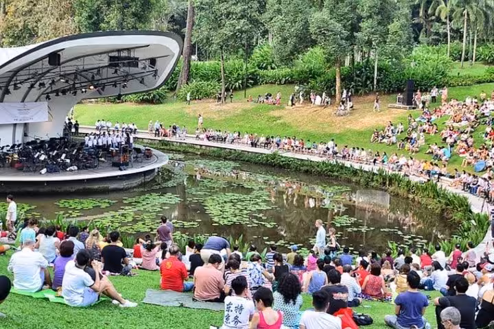 Visitors enjoy a live performance at the Singapore Botanic Gardens, a highlight of the guided tour including Chinatown.