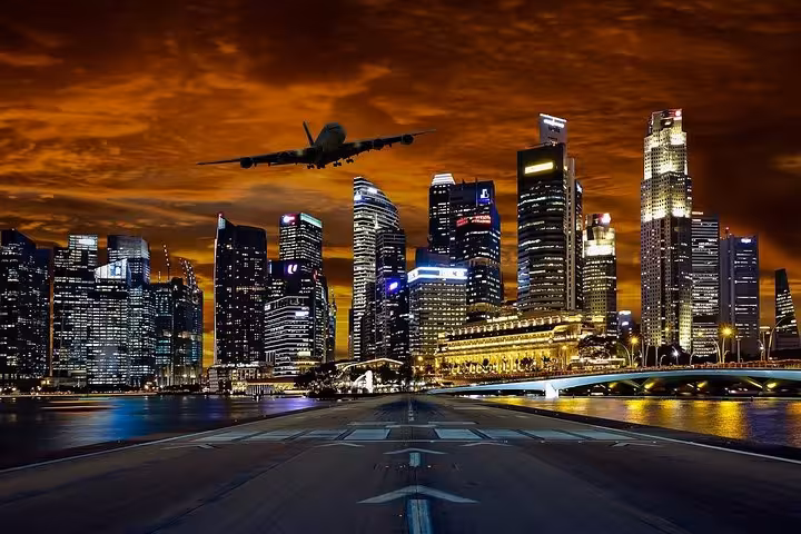 Night Marina Bay skyline with plane overhead, iconic photo stop on 6-hour Singapore tour by private car