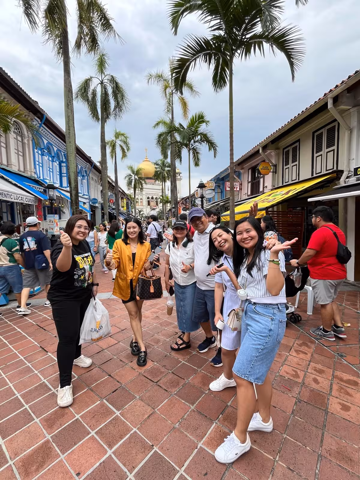 Tourists enjoying a lively street scene near Sultan Mosque, Singapore with a guided cultural tour experience.