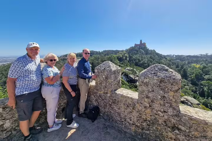 Group enjoying panoramic view of Sintra's lush landscape and historic castle during a private tour from Lisbon with monument tickets.