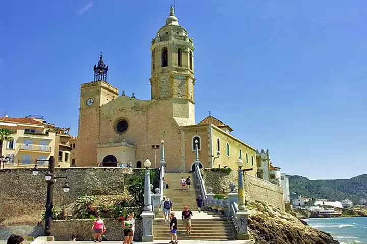 Stunning view of the historic church by the sea in Sitges, perfect for exploring on a guided tour.