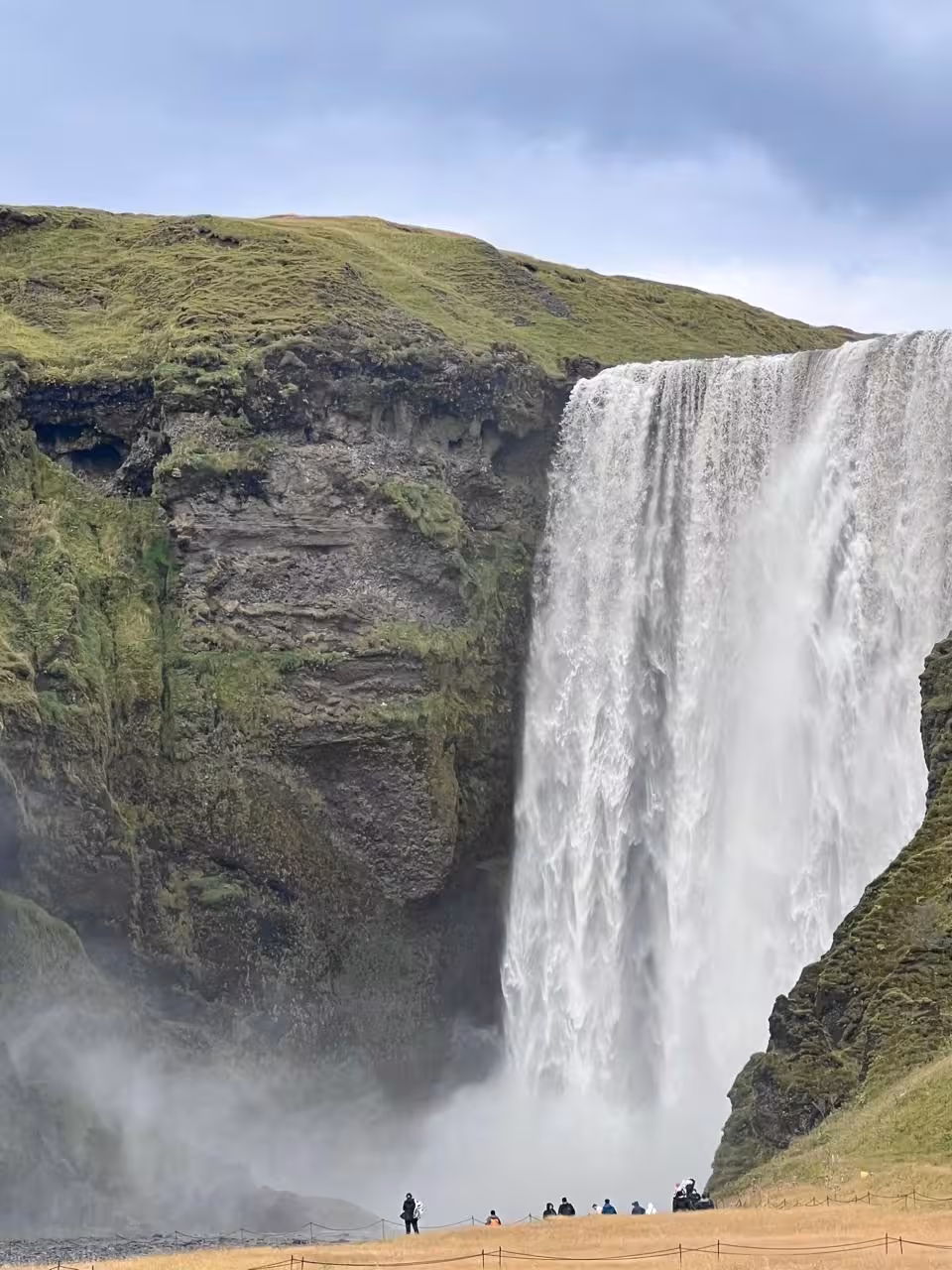 Skogafoss waterfall viewpoint on Iceland South Coast private tour from Reykjavik, misty falls and cliffs