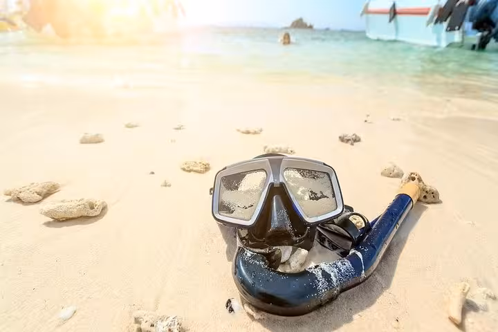 Snorkel mask on sandy Red Sea beach in Hurghada, ideal for Luxor to Hurghada snorkeling day trip