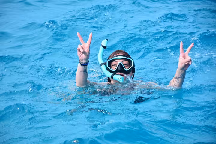 Snorkeler in crystal-clear Red Sea on Orange Bay and Giftun Island boat trip from Hurghada with lunch