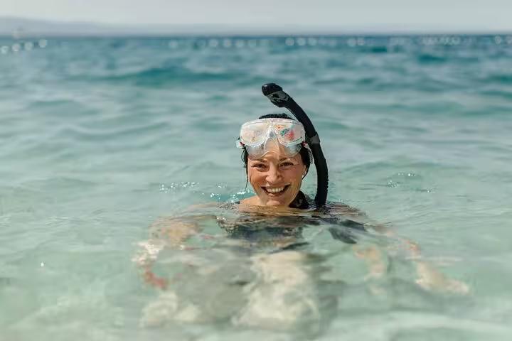 Smiling snorkeler in clear Red Sea water at Sharm El Sheikh, ideal add-on to semi submarine tour trip